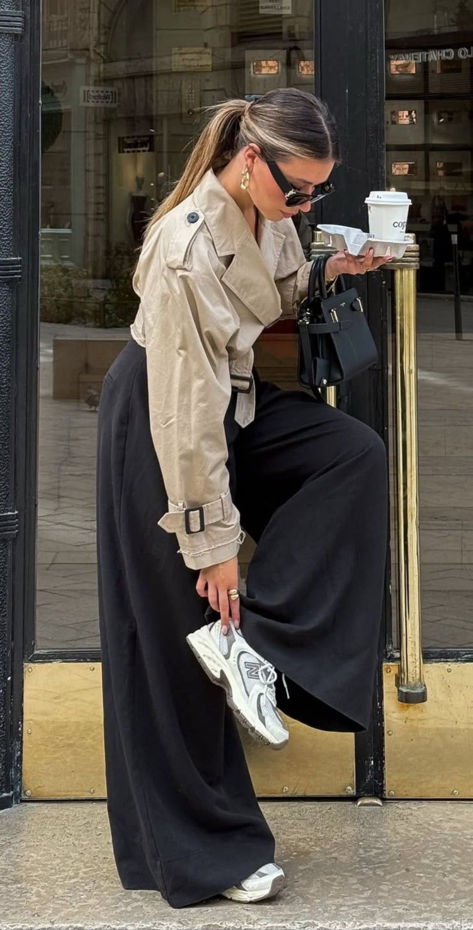 Look con trench corto y pantalón ancho negro